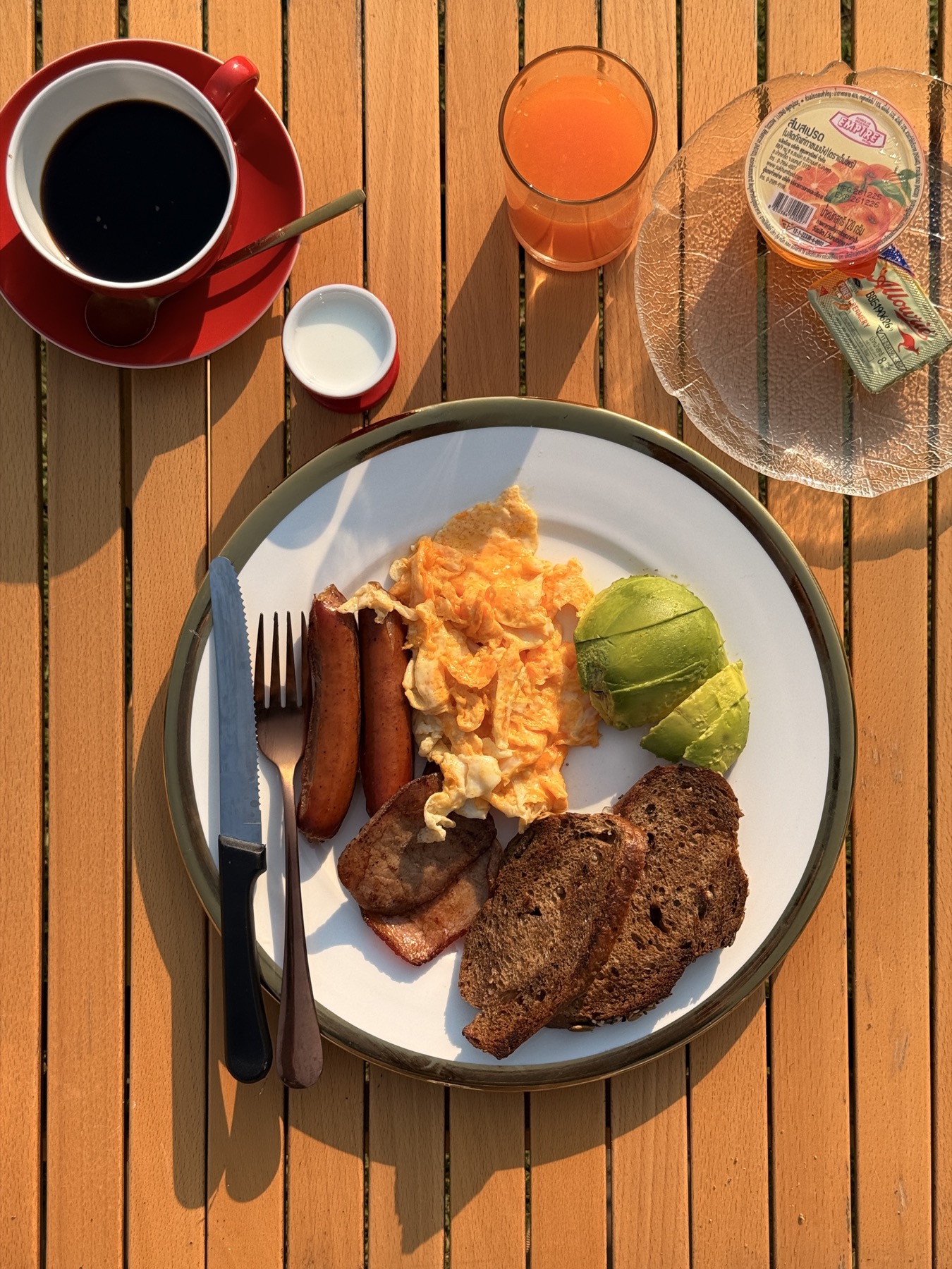Full breakfast — scrambled eggs, sausage, avocado, toast, coffee