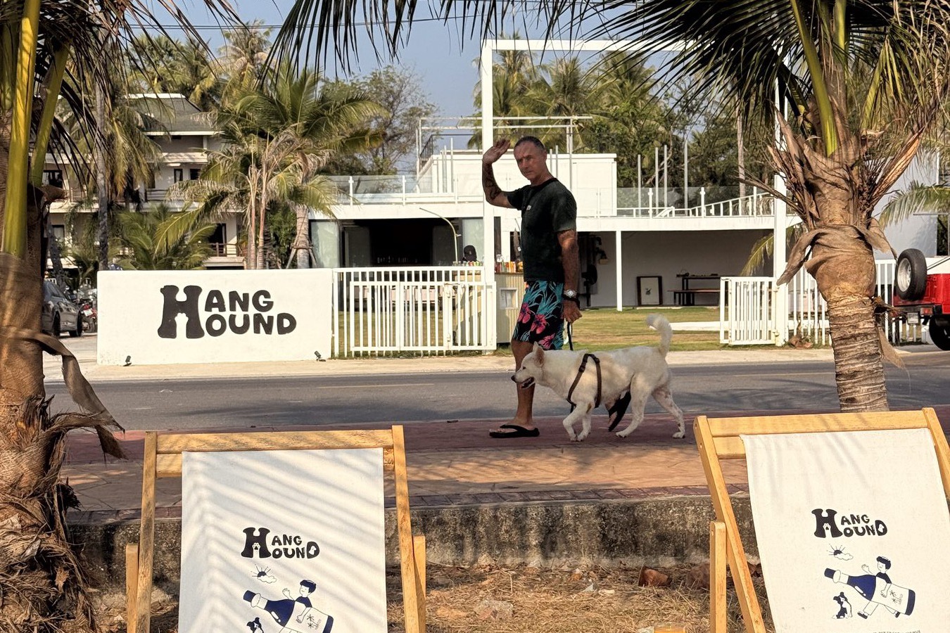 Hang Hound — branded chairs, a dog, and a man waving hello